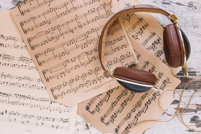 different music sheets with head phones symbolizing the different types of music transcription